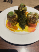 Beef and pork albondigas served with polenta and fried kale